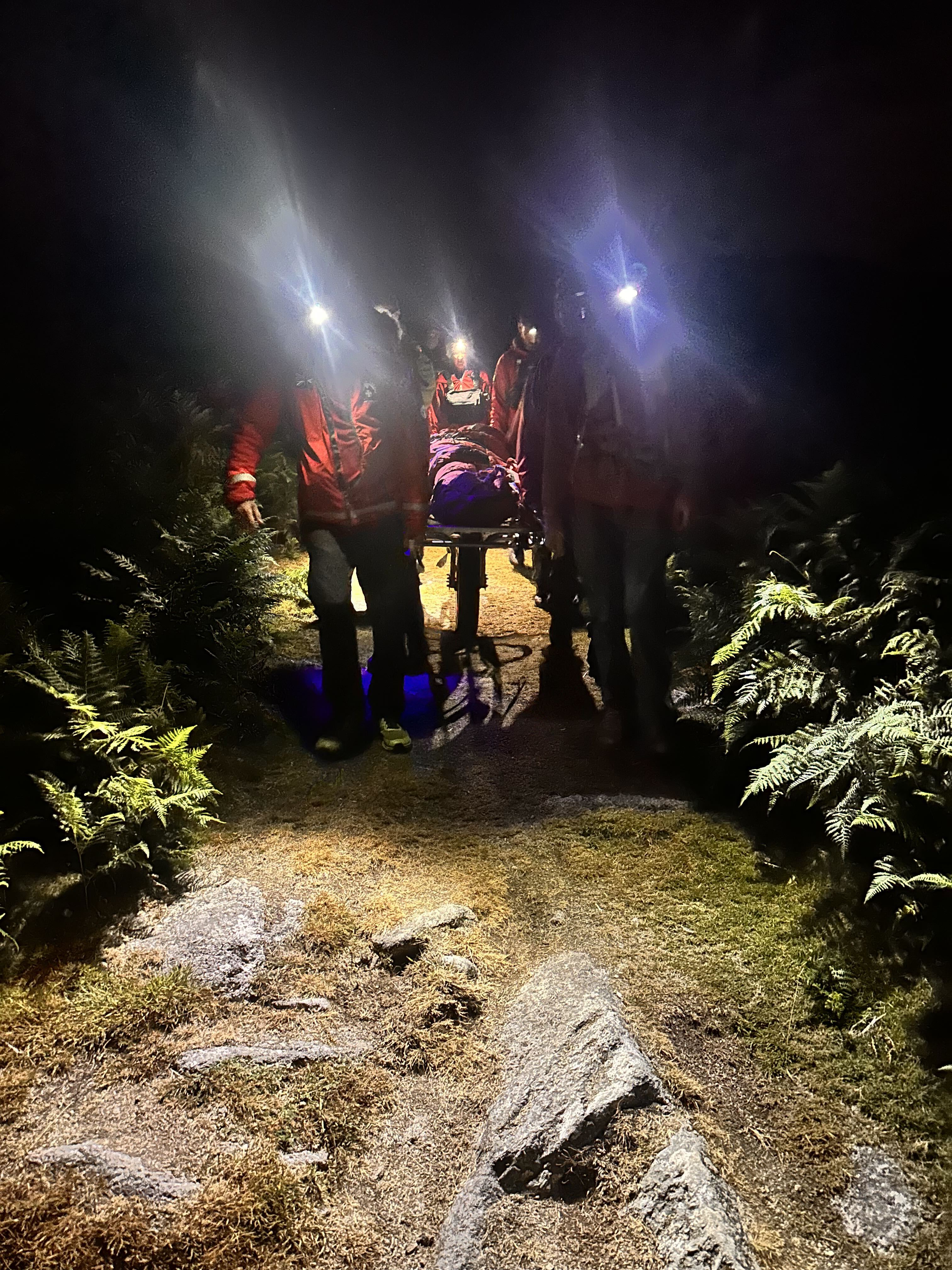 The team carrying a stretcher down from Sheepstor