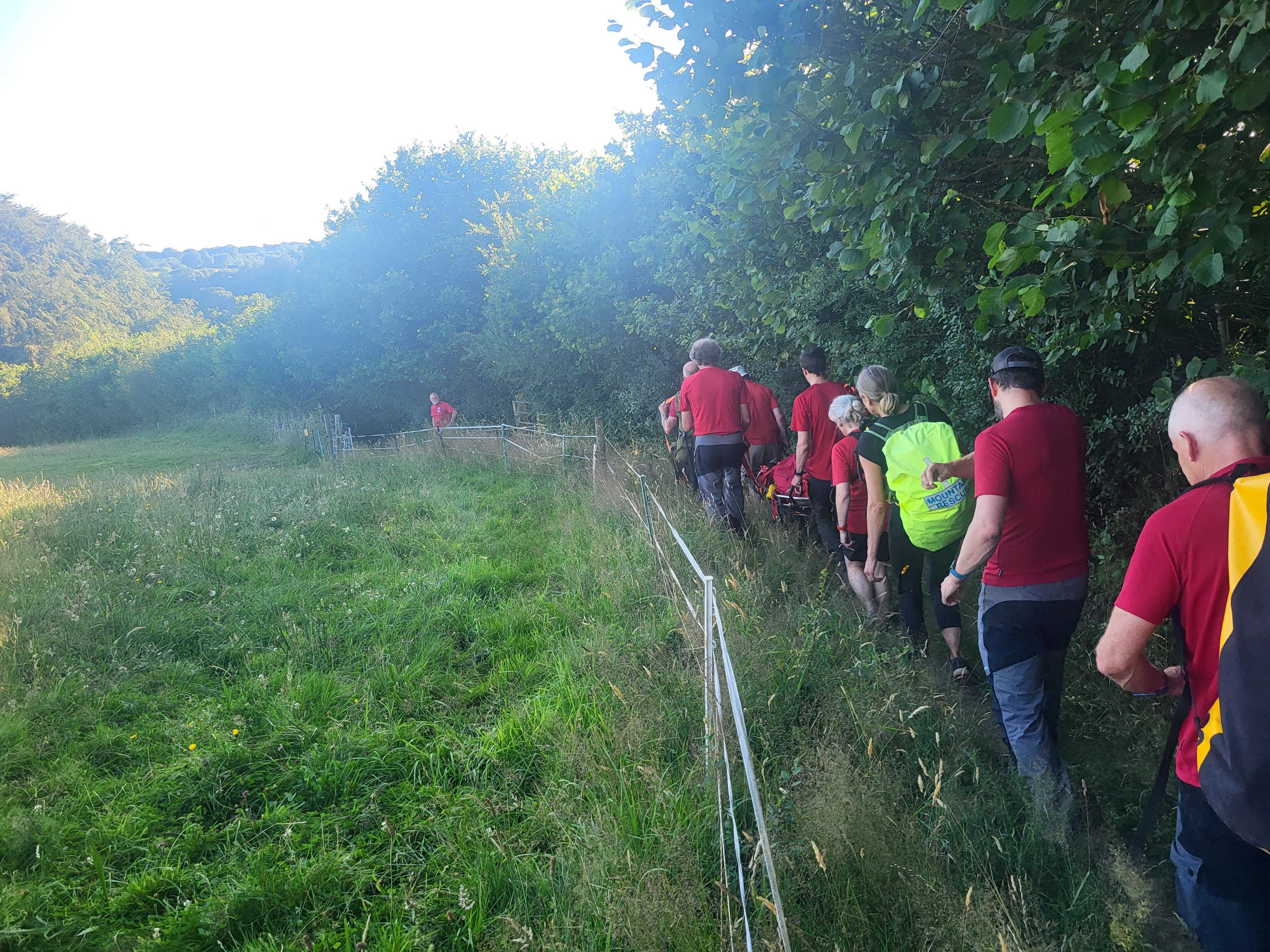 The team carrying the stretchered casualty down the path back to Horrabridge